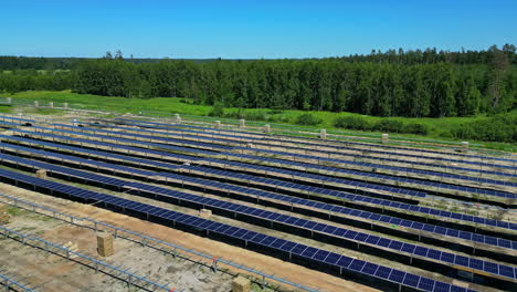solar panels installation process in big forest space. aerial view