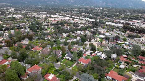 Aerial-View-of-Pasadena,-Residential-Neighborhood,-Homes-and-Traffic-on-Highway,-Drone-Shot