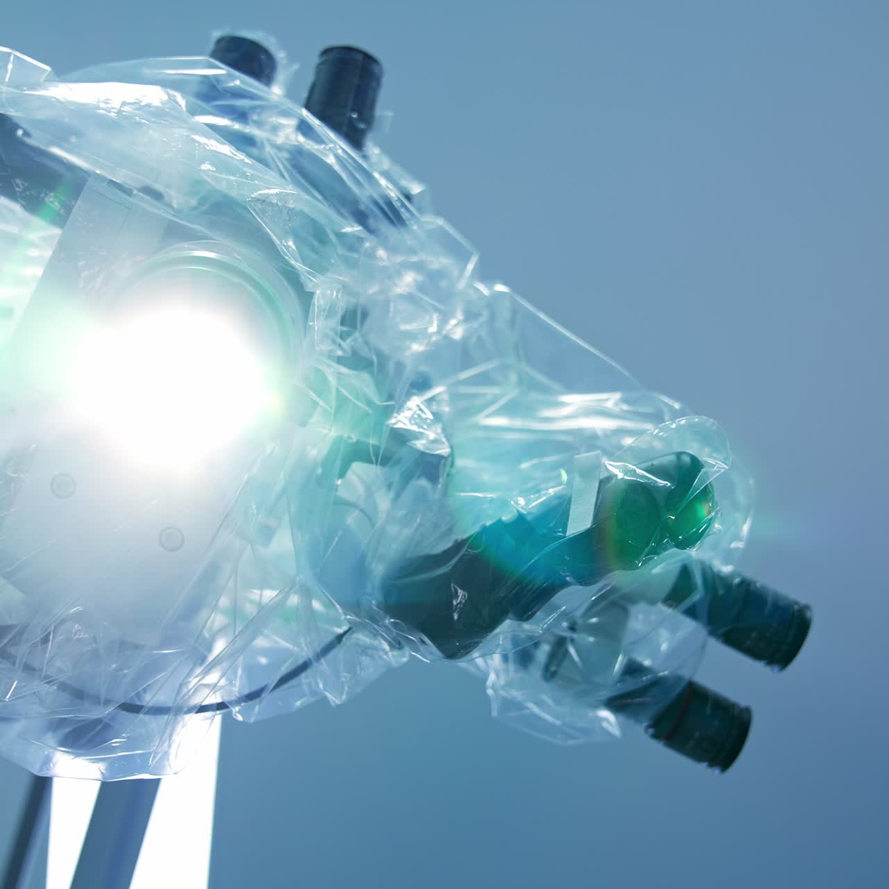 Surgical microscope of great precise switched on in operational room. Advanced technological equipment covered in plastic for sterility. Low angle view