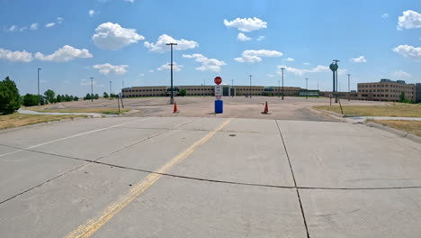 empty parking lot of a large office building on a sunny day