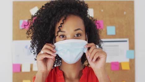 portrait of woman wearing face mask at office