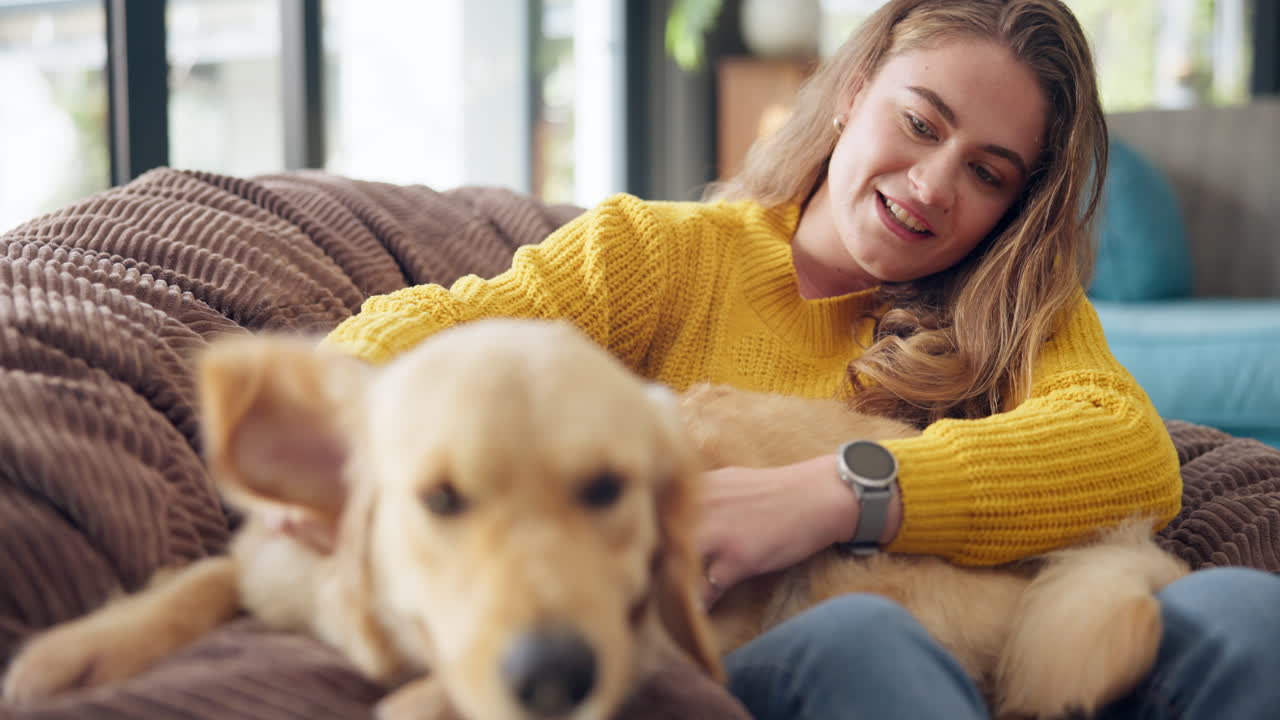 A woman relaxing on a couch with her dog
