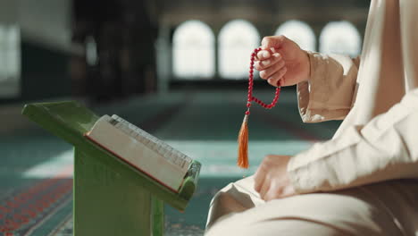 islam, cuentas de oración y hombre en la mezquita con el corán