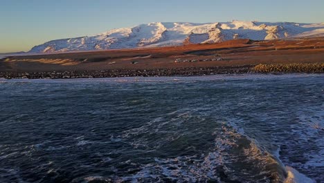 El-Pintoresco-Paisaje-De-Islandia-A-Lo-Largo-De-La-Costa-Con-Olas-Del-Océano-Y-Fondo-Montañoso