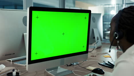 businesswoman using a green screen computer in a call center.