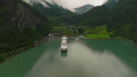 high angle aerial over scenic geiranger fjord with docked cruise ship, norway