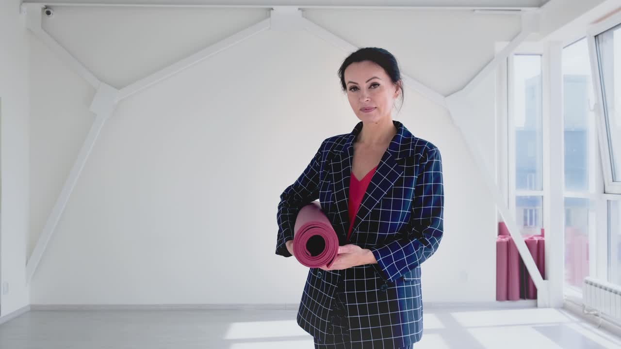 Businesswoman with Yoga Mat in Modern Office