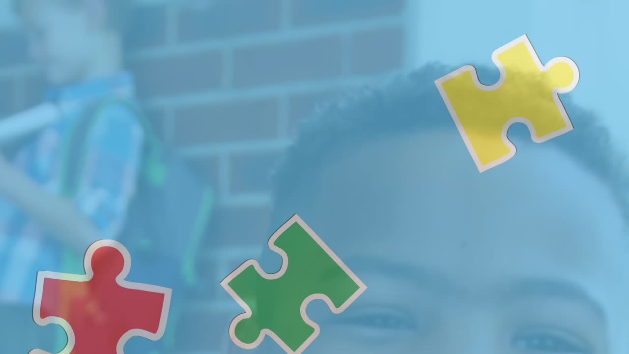 The video shows a happy african american boy holding books in front of a school