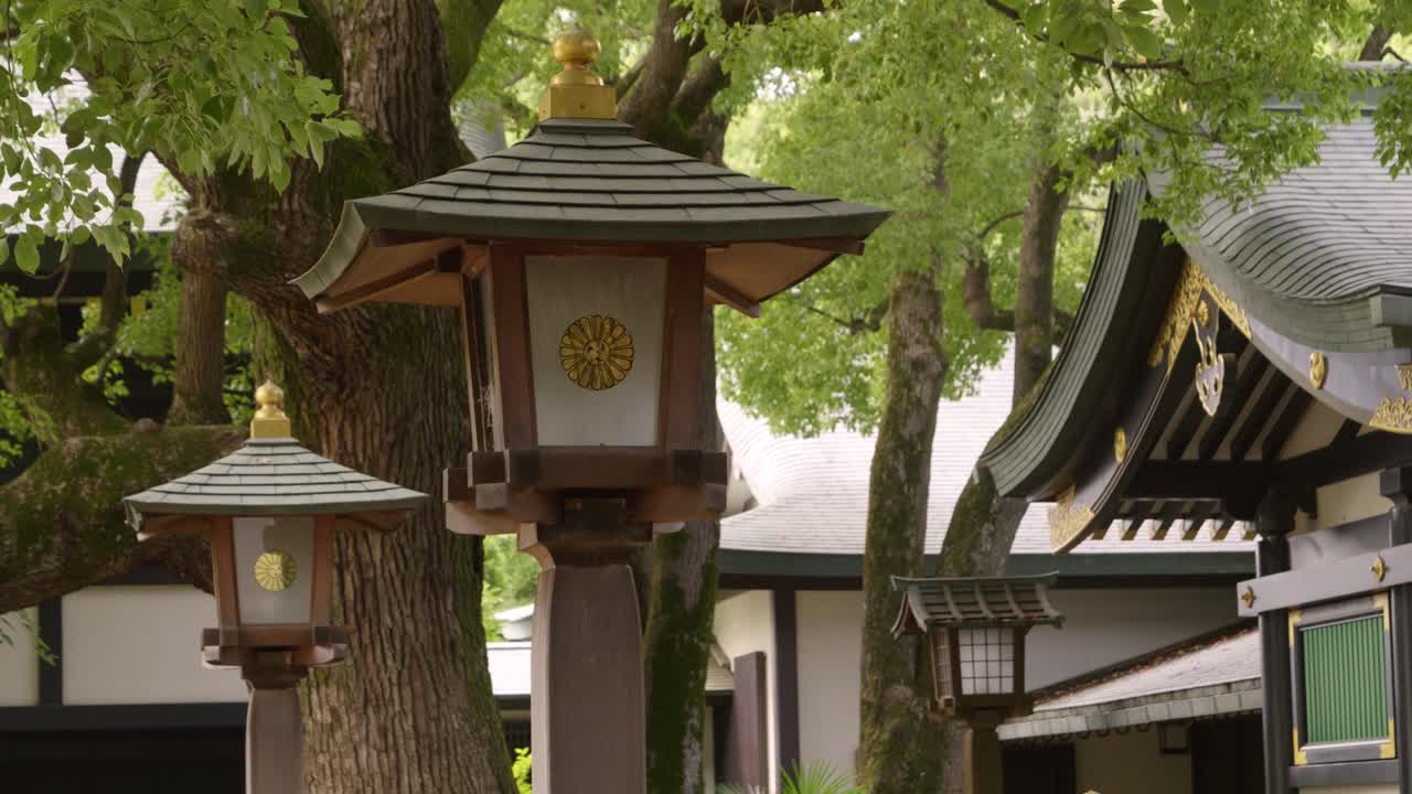 Beautiful slow motion slider over Japanese temple grounds with lush greens
