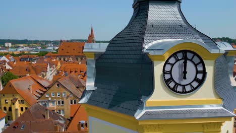 4k aerial drone video of the clock tower, st. johannis kirche church, and kirche st. gumbertus church in ansbach, germany