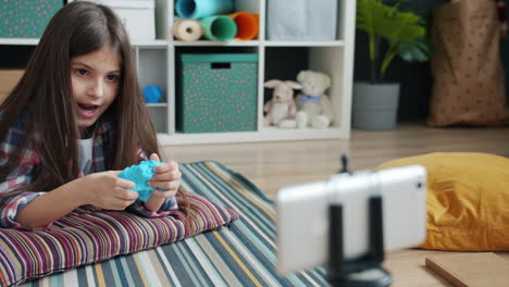 girl plays with blue slime