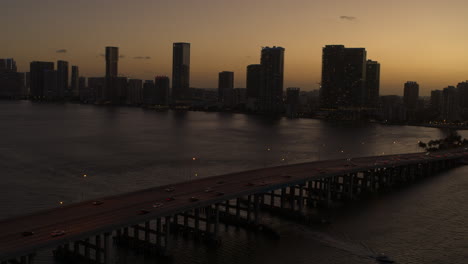 miami bridge with downtown miami in the background at sunset aerial shot