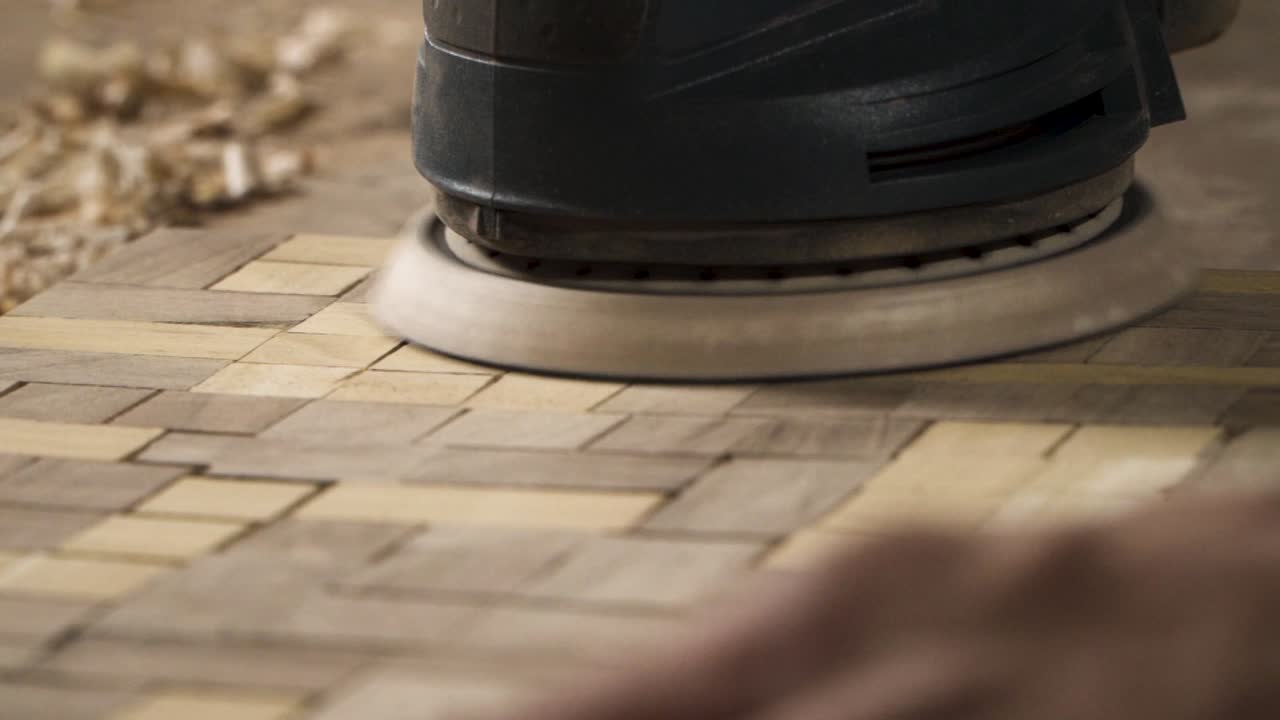 Close up shot of a machine sanding wood
