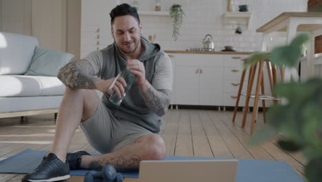 man doing online fitness workout at home