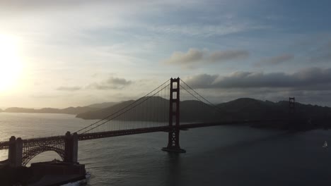 beautiful sunset over the golden gate bridge. slow aerial reverse over the san francisco bay.