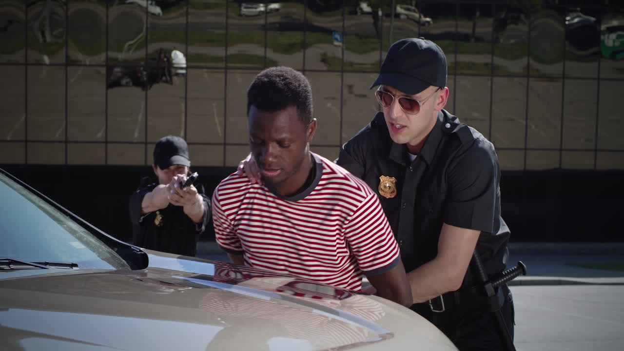 Police arrest suspect against car