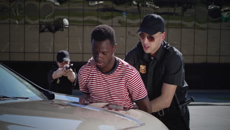 police arrest suspect against car