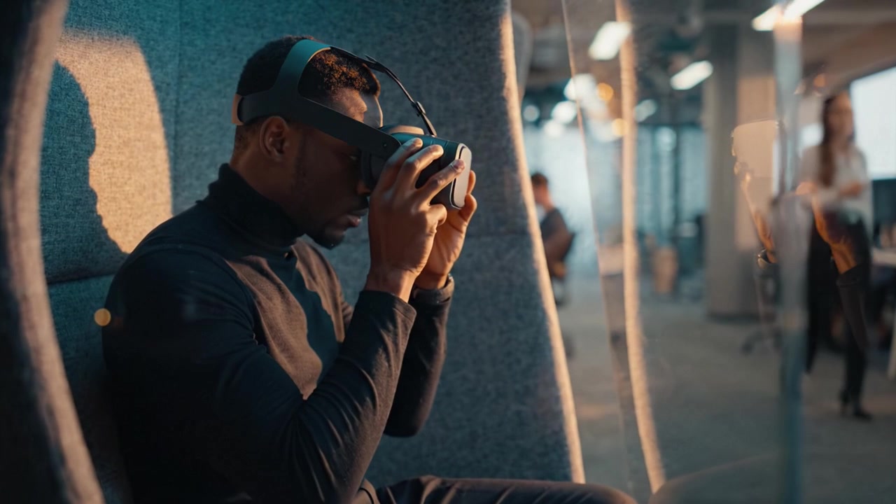 Immersive Virtual Reality Experience: A Focused Individual Engaging with Advanced Technology in a Modern Workspace Setting, Showcasing the Future of Digital Interaction