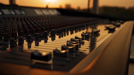 professional audio mixing console at sunset or sunrise