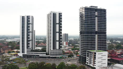 aerial drone shot flying around a busy intersection amongst high rise buildings in liverpool sydney australia