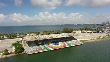 an abandoned run-down stadium on the shoreline