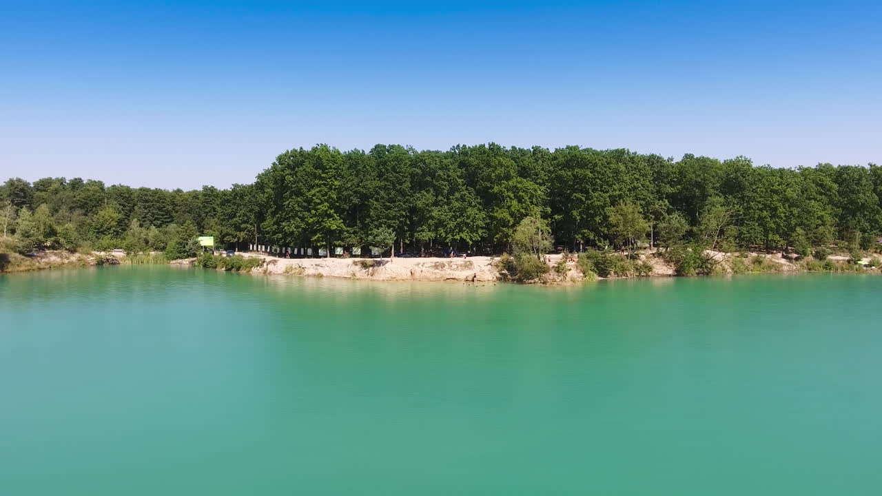 Scenic Lakeside View with Forest and Turquoise Water