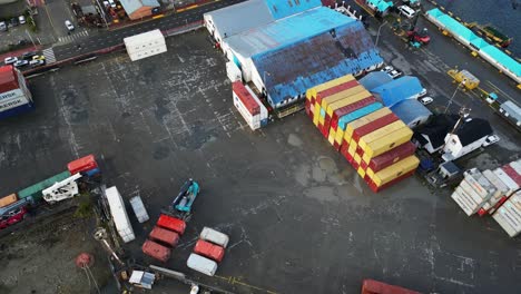 containers docked in customs sea port transportation of ushuaia aerial above argentinian patagonian southernmost antarctic gateway