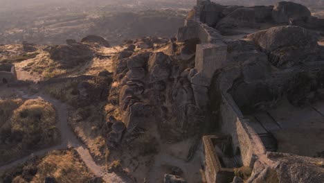 Aerial-forward-over-defensive-walls-of-Monsanto-castle-at-sunrise