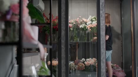 florist arranging flowers in shop