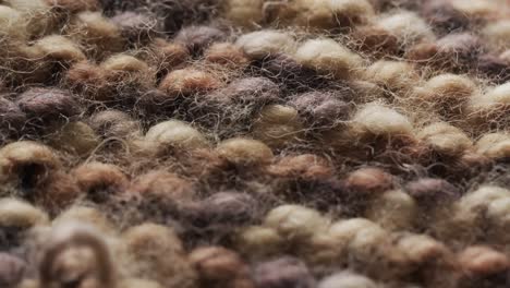 micro video of close up of brown wooly crochet fabric with copy space