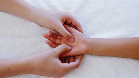 female physiotherapist giving hand massage to boy patient 4k