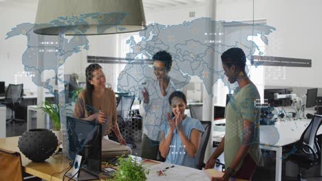 Animation-of-world-map-against-diverse-colleagues-clapping-and-high-fiving-each-other-at-office
