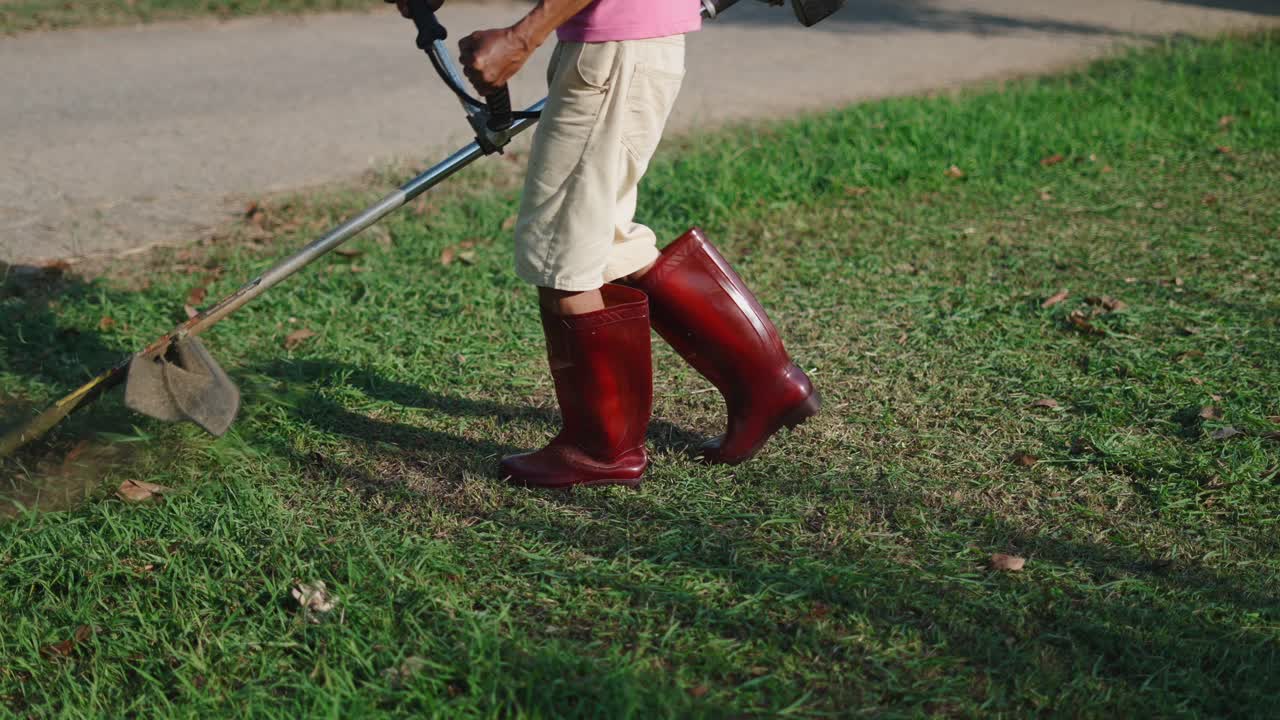 Woman mowing the lawn