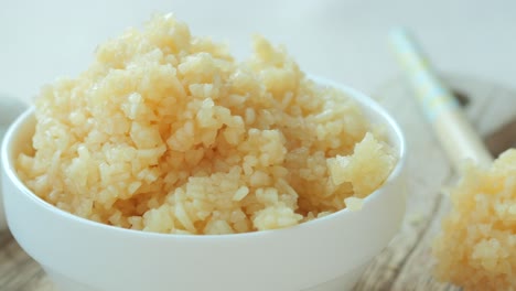 close up of minced garlic on a wooden spoon ,