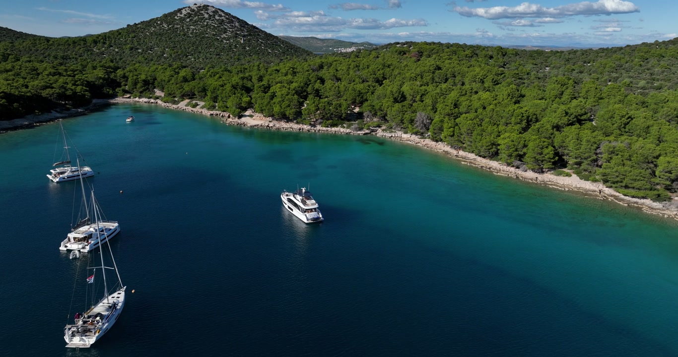 Aerial: Adriatic Sea with yachts during the day in Sibenik, Croatia, establishing drone shot