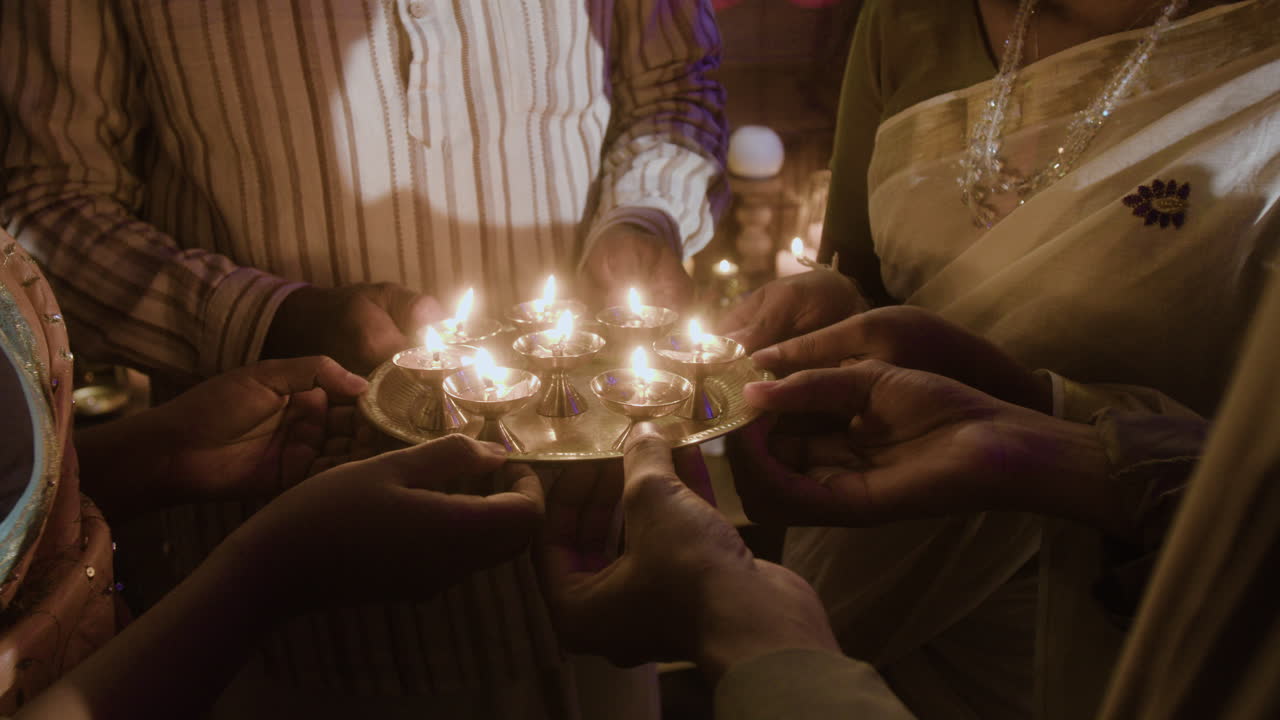 Family celebrating Diwali with candles