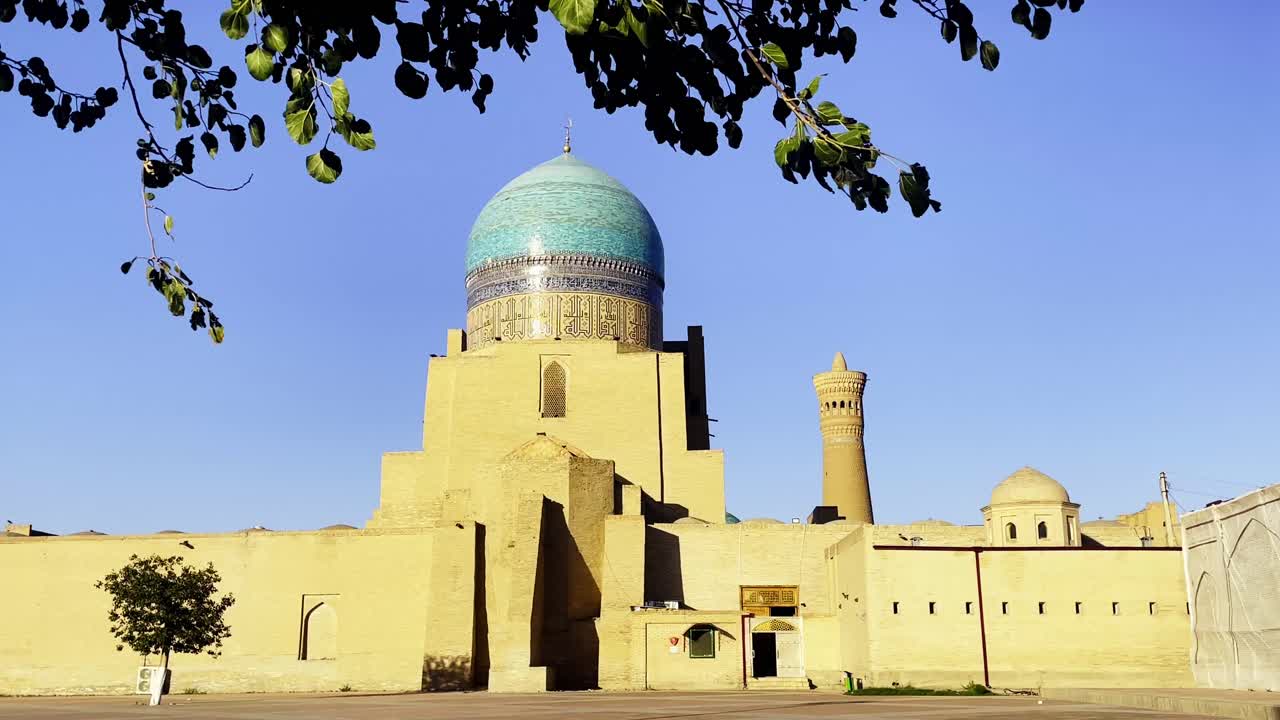 Po-i-Kalyan Mosque in Bukhara, Uzbekistan. The shot captures the blue-tiled dome and the grand facade of this Islamic architectural masterpiece, landmark of Silk Road and a UNESCO World Heritage site