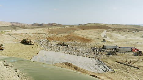 Large Landfill Site with Heavy Machinery and Workers