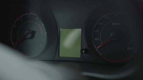 instrument cluster dashboard illuminates multiple warning lights and digital display readings including time odometer and fuel gauge bars on engine start highlighting interior details