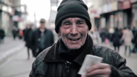 an elderly man shares a joyful moment while smiling and conversing with people on a busy city street filled with pedestrians on a chilly day.