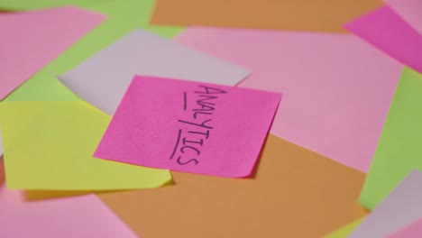 business concept of revolving sticky notes with analytics written on top note 1