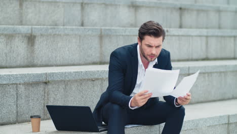 business man working with documents on street. entrepreneur reading documents