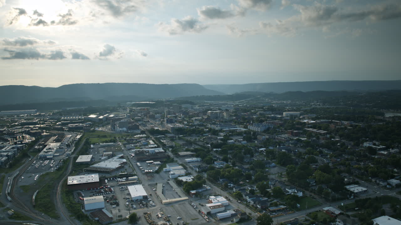 Aerial hyperlapse at sunset showing trains and traffic and downtown Chattanooga, Tennessee