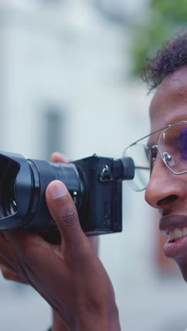 person holding a camera with a lens