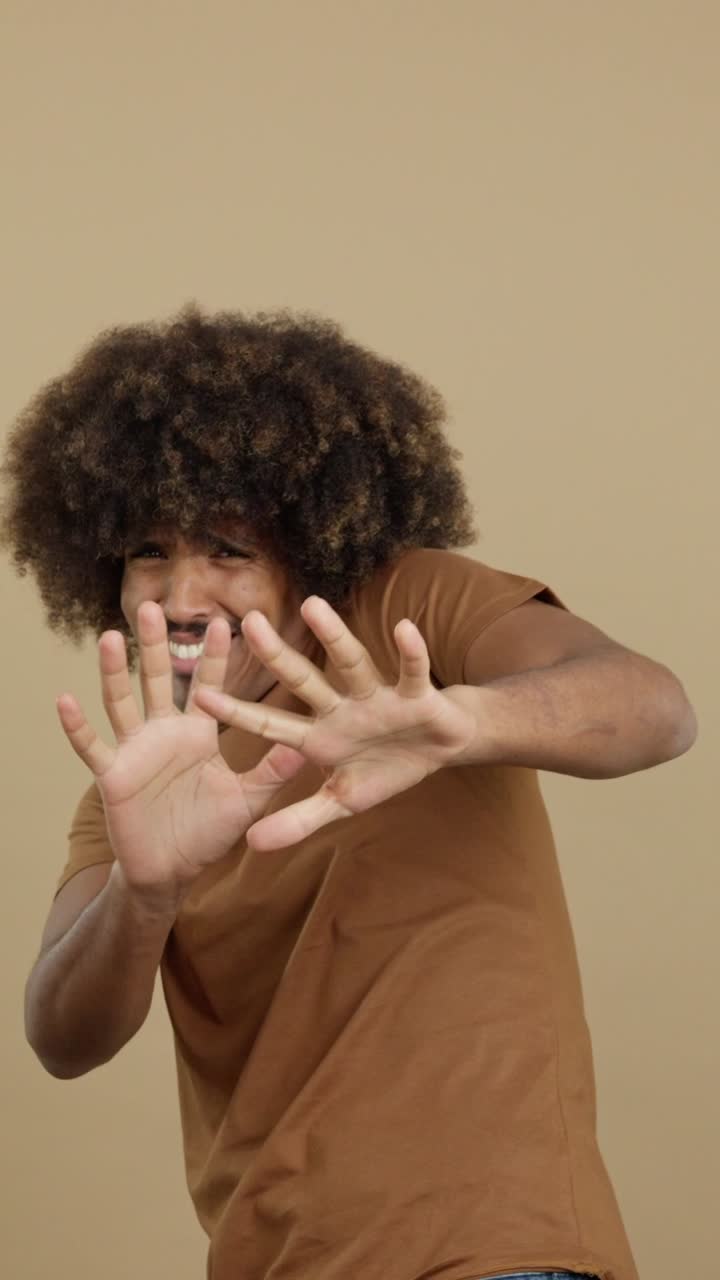 Man with Afro and Mustache Expressing Denial or Displeasure