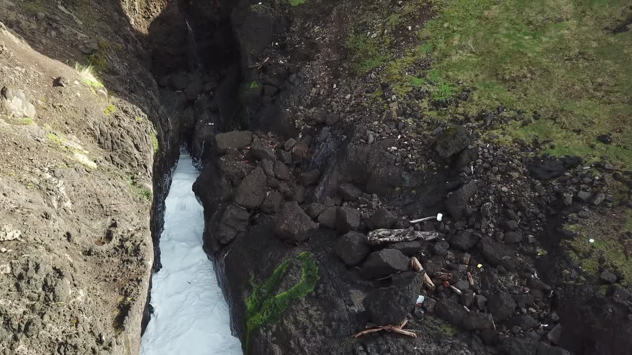 Large Waterfall next to Ocean Aerial View