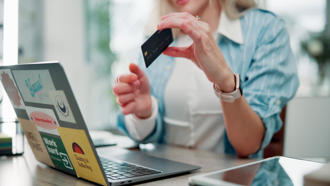 Woman using credit card for online shopping on laptop