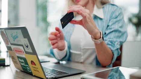 woman using credit card for online shopping on laptop