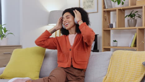 woman, dancing and music on headphones on a living