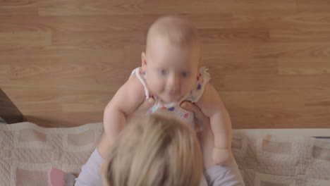 mother playing with her newborn daughter